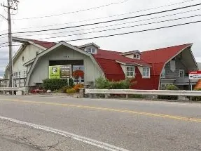 The Gristmill building and its red barn roof, seen from Bellevue Road.