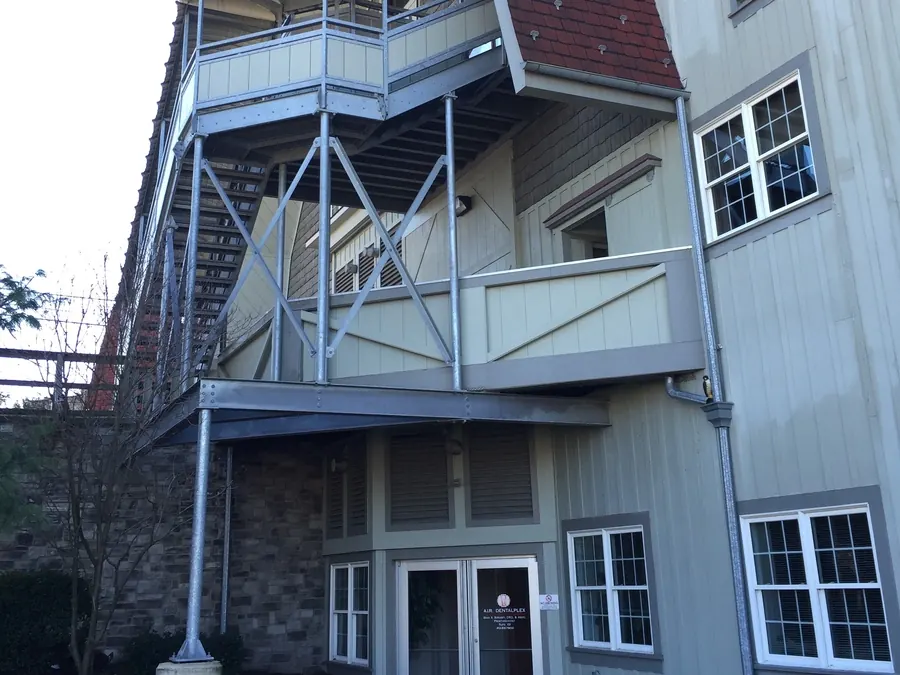 The first-floor entry of the Gristmill building, beneath its timber balconies.